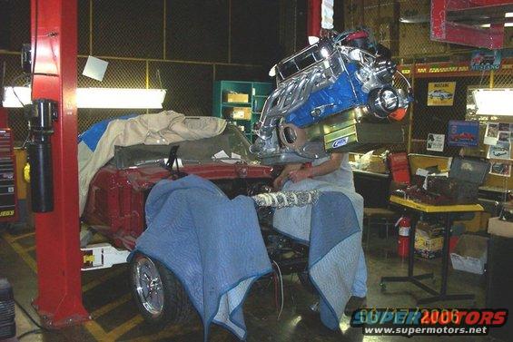 Using a forklift to lower the motor in the car. - $20,000  cherry picker:)
