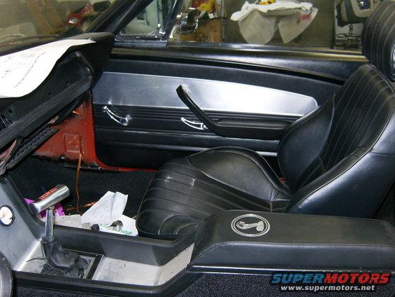 Burton Custom Door Panels.
Fox body arm rest
Billett Specialties door hardware.

Ellinore console

B&M Unimatic shifter (for pick-up truck conversions) with 3 inches cut out and hidden under the manual shifter boot. turned the handle a little and it looks like a standard.