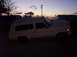 1988 Ford Bronco - Full-size SUV with a camper shell parked outside at dusk.
