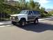 1986 Ford Bronco - This lifted 1986 Ford Bronco features a two-tone white and grey paint scheme and auxiliary yellow fog lights.