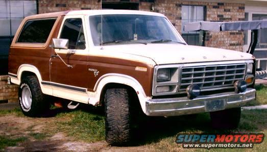 1980 Ford Bronco with brown and white paint, lifted suspension, and aftermarket wheels