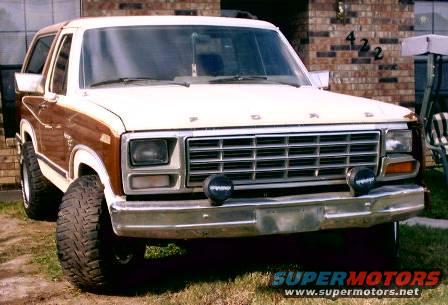 Ford Bronco with wood paneling, front view. Has aftermarket lights on bumper