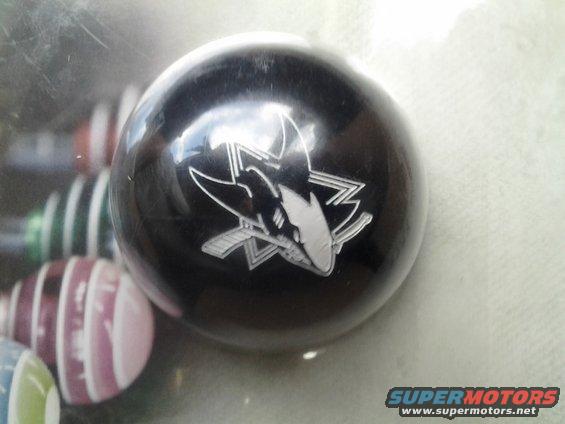 Black shift knob with San Jose Sharks logo, other shift knobs in background
