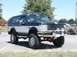 1994 Ford Bronco - This lifted Ford Bronco features a two-tone paint job and aftermarket off-road accessories.
