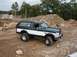 1994 Ford Bronco - 1994 Ford Bronco on a construction site with piles of dirt and rocks.