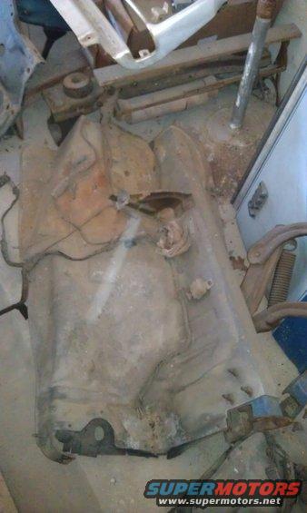 car's undercarriage part, possibly fuel tank or frame section