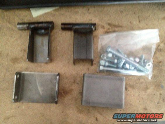 Metal brackets and hardware on a workbench