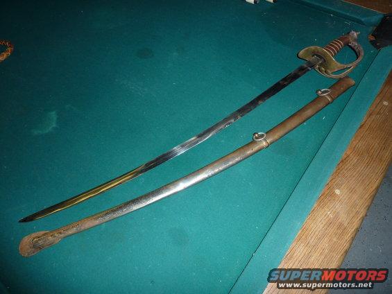 Sword and scabbard on a pool table