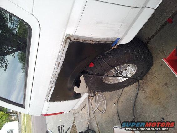 1996 Ford Bronco rear fender being welded, showing the wheel well and part of the rear quarter panel