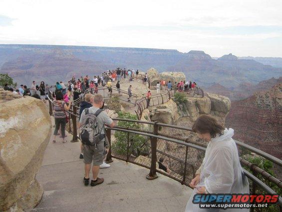 Tourists on a walkway overlooking the Grand Canyon