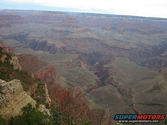 Grand Canyon landscape with layered rock formations and a distant river