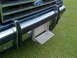 1992 Ford Bronco - Close-up of the front grille and bumper of a 1992 Ford Bronco, a fold-down step.