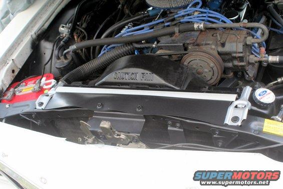 Engine bay with Ford Racing coolant cap and "CAUTION FAN" shroud