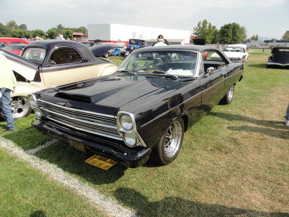 Black 1966 Ford Fairlane GT with hood scoop and chrome wheels
