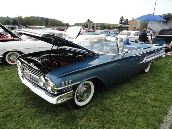Blue 1959 convertible with hood open, showing engine. Whitewall tires, chrome accents