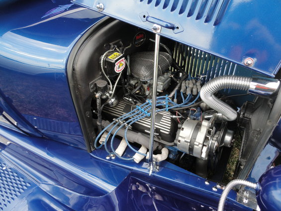 Blue hot rod engine bay with chrome accents and blue spark plug wires