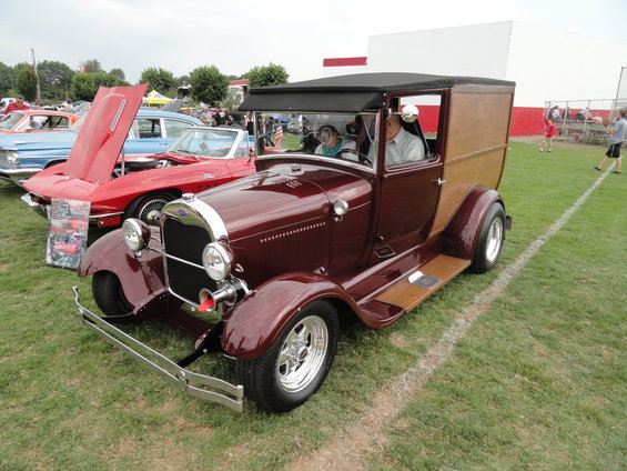 Maroon 1929 Ford Model AA truck with wood panel rear, chrome grille, and aftermarket wheels