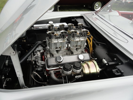 Close-up of a V8 engine with six carburetors and yellow spark plug wires