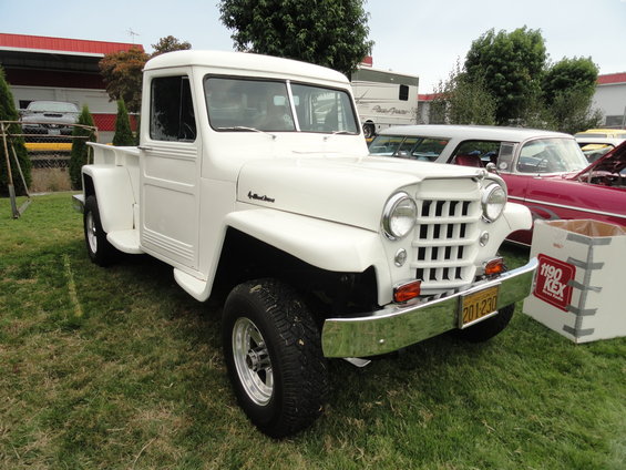 White Willys pickup truck with a chrome grille and bumper. License plate reads 201-230