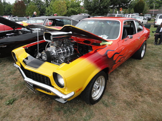 Yellow and red hot rod with flames and exposed supercharger, front 3/4 view