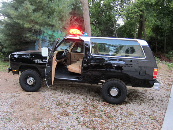 1987 Dodge Ramcharger SUV, black with tan interior, police light bar, driver door open