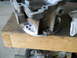 1992 Ford Bronco - A metal engine part rests on a wooden workbench next to a white cloth.