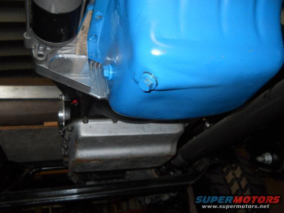 Blue painted engine oil pan with silver fins and a bolt on the side