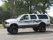 2001 Ford Excursion - This lifted 2001 Ford Excursion features custom skull graphics along its side.