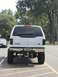 2001 Ford Excursion - Rear view of a white 2001 Ford Excursion, modified with a lift kit and large tires, parked in a lot.