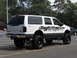 2001 Ford Excursion - White 2001 Ford Excursion with skull decals and lifted suspension.