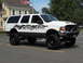 2001 Ford Excursion - This modified SUV features large tires and a prominent skull graphic along its lower body panels.