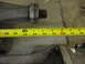 1971 Ford Ranchero - A measuring tape is placed against a metal automotive differential housing, indicating a length of about 16 inches.