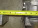 1971 Ford Ranchero - A metal part is being measured with a tape measure. The part is silver-colored and the tape measure is yellow.