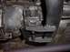 1991 Ford Crown Victoria - Close-up view of an engine mount and exhaust pipe, showing mechanical components and some grease.