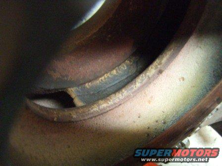 close-up of a rusty exhaust manifold with some discoloration