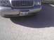 2003 Ford Crown Victoria - The front grille and headlights of a silver Ford Crown Victoria are visible, along with its license plate.