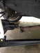 1996 Ford F-150 - Underside view of a vehicle's drivetrain components, showing the driveshaft and differential connection.