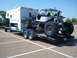 1967 Ford Mustang - A custom-built off-road buggy is transported on a trailer behind a pickup truck with a camper.