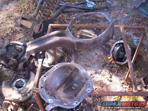 Rusty differential covers and suspension parts scattered on the ground