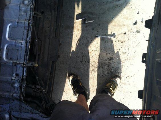 Interior of a stripped-down vehicle with tools on the floor