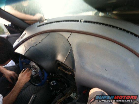 Cracked dashboard interior with blue steering wheel
