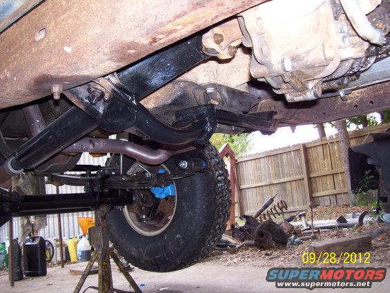 Underside of a 1990 Ford Bronco, showing suspension and drivetrain components
