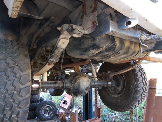 Rear suspension and fuel tank of a vehicle, showing leaf springs and differential