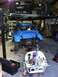 1970 Volkswagen Beetle - A blue Volkswagen Beetle is being worked on in a garage, with its engine removed and placed nearby.