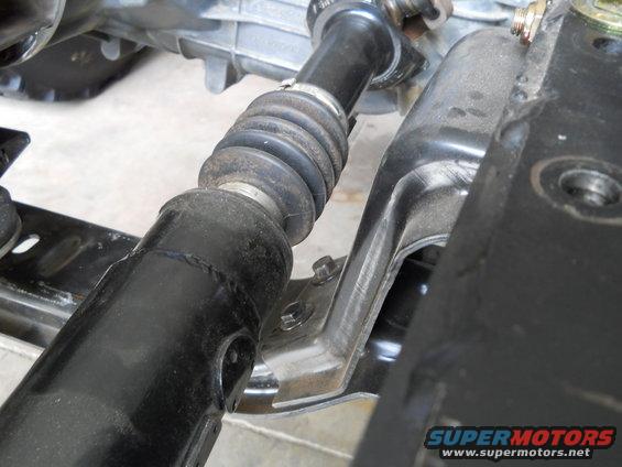 Driveshaft boot and mounting bracket on a vehicle's undercarriage