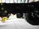 1992 Ford Bronco - The underside of a vehicle, focusing on the frame and a large off-road tire.