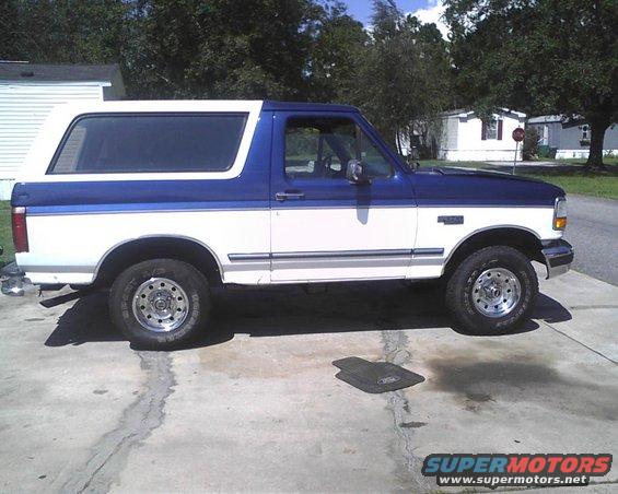 1996 Ford Bronco, two-tone white and blue, parked on concrete driveway
