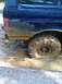 1990 Ford Bronco - This 1990 Ford Bronco is deep in the mud, showing its rear wheel and lower body panels.