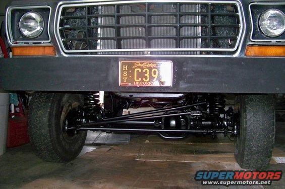 Front view of a 1978 Ford Bronco showing grille, headlights, bumper, and suspension components