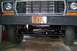 1978 Ford Bronco - The front grille and headlights of a 1978 Ford Bronco are visible, along with its suspension system.